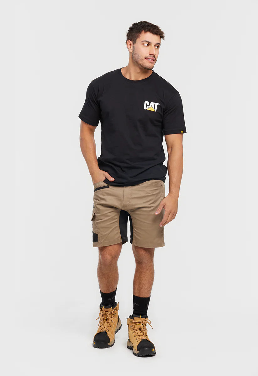 Man wearing a black t-shirt with a logo, beige cargo shorts, and work boots on a white background