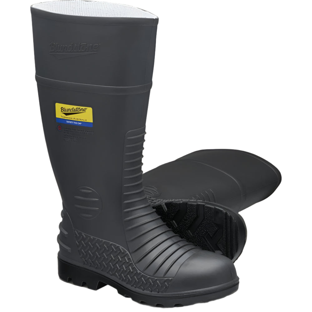 Pair of black rubber boots with a visible brand label on a beige background