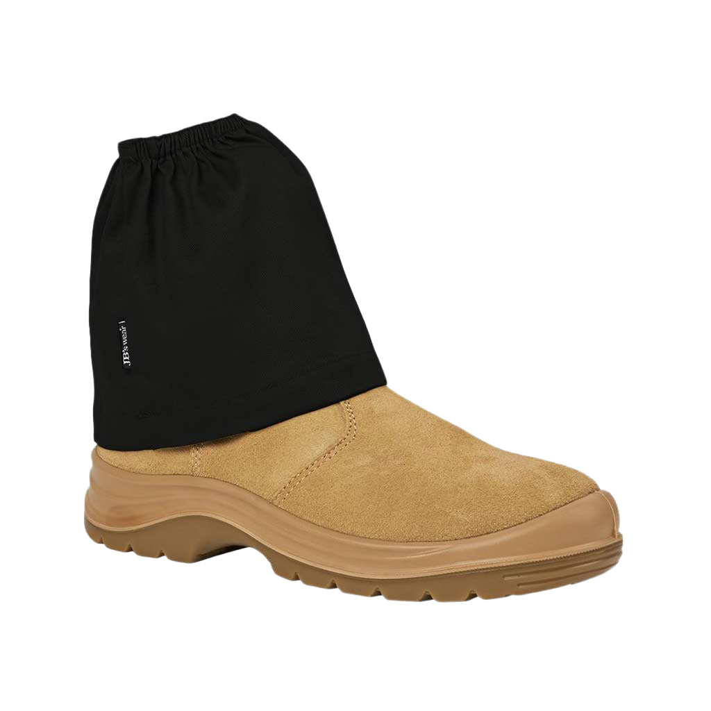 Tan boot with a black gaiter on a textured gray background